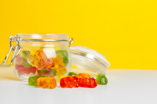 Bottles with sweet candies on table