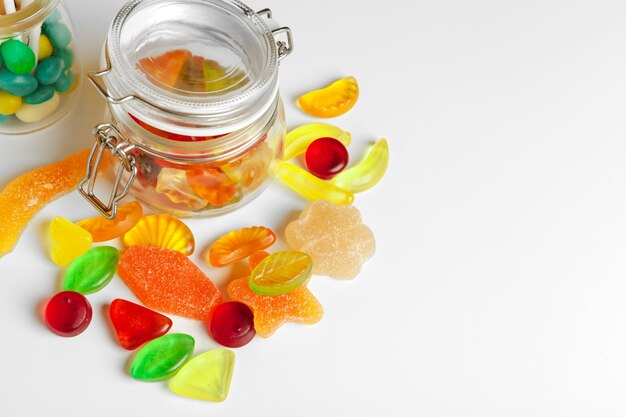 Bottles with sweet candies on table