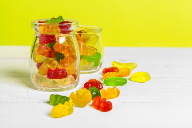 Photo bottles with sweet candies on table