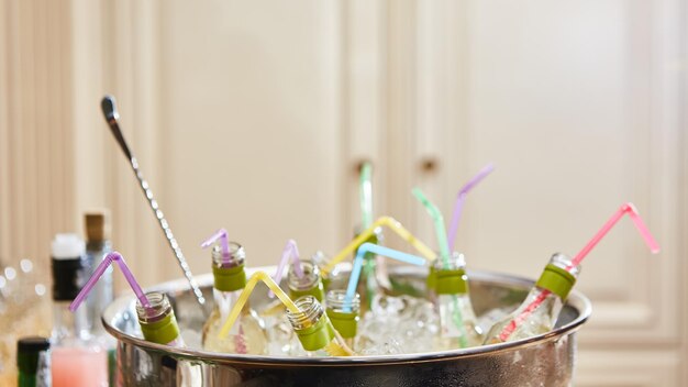 Bottles with tasty drink in ice Shallow dof