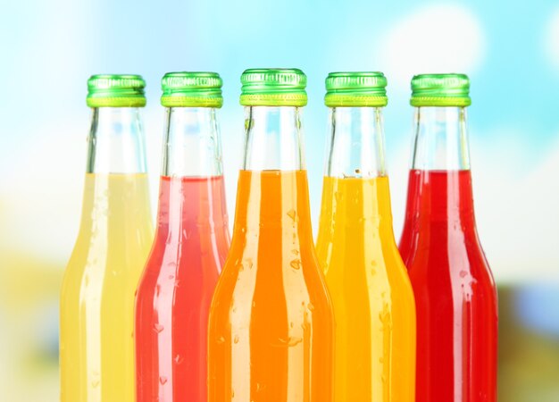 Bottles with tasty drinks on bright