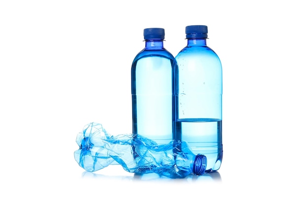 Photo bottles with water and used bottle isolated on white background