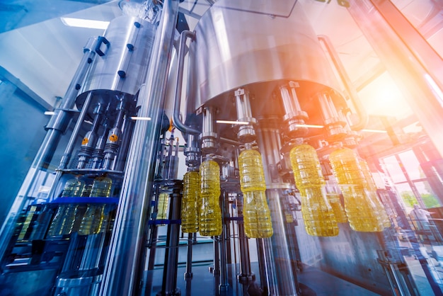 Bottling line of sunflower oil in bottles. Vegetable oil production plant.