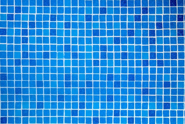 Bottom of the pool water texture Sun reflection on the blue clear water ripples of pool with tile bottom