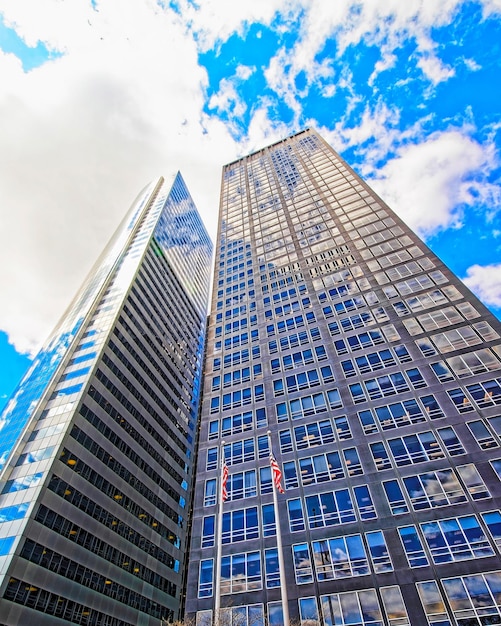 Photo bottom up street view on financial district of lower manhattan, new york city, nyc, usa. skyscrapers tall glass buildings united states of america. blue sky on background. empty place for copy space.