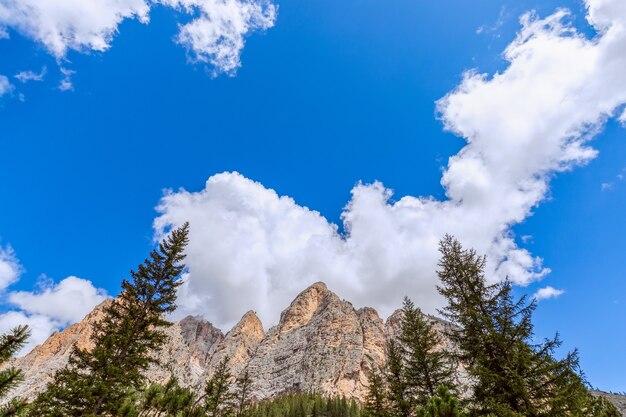 Bottom up view of the Italian Dolomites against clear blue sky