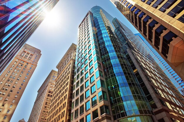 Bottom-up view to skyscrapers mirrored in glass in Philadelphia, Pennsylvania, USA. It is central business district in Philadelphia