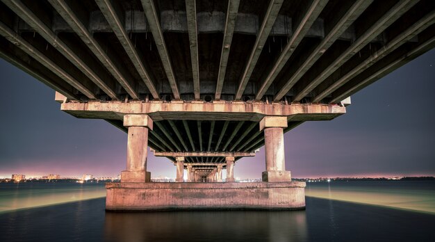 Bottom view of a beautiful bright long bridge over the big beautiful Dnieper river