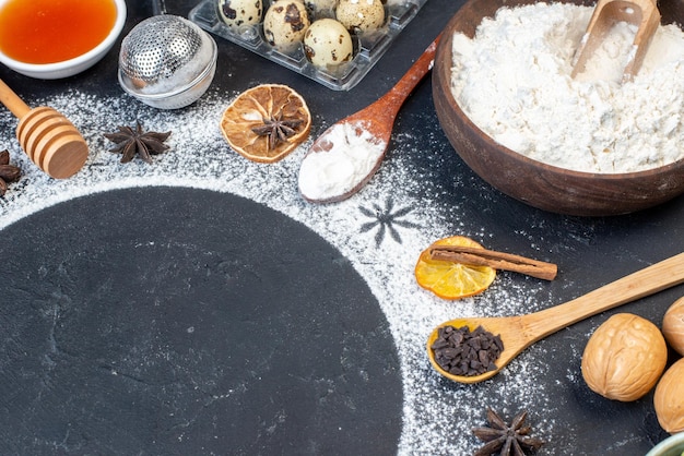 Bottom view circular frame made of wheat flour anise stars flour honey in bowls quail eggs on table