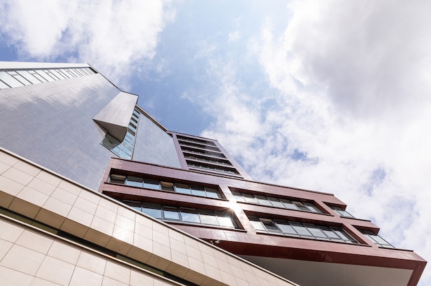 Bottom view of cutting-edge apartment building with geometry design facade.