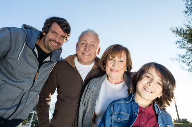 Bottom view of happy family at sunset