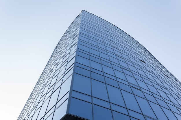 Bottom view of modern skyscrapers in business district against blue sky.