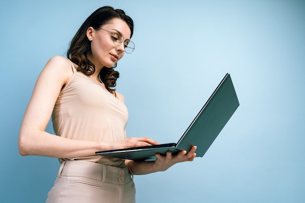 Bottom view. Portrait of a pretty businesswoman working on laptop