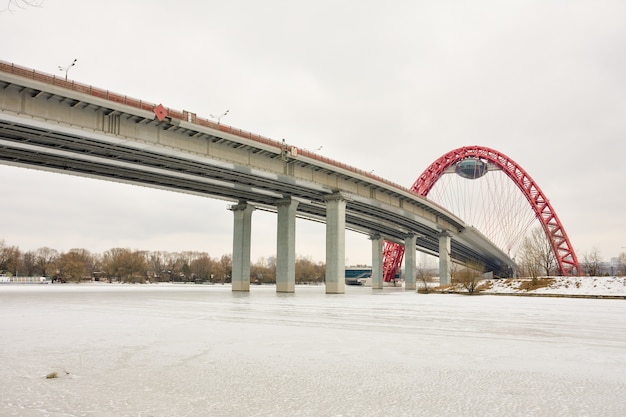 Bottom view of the road bridge with a red arch