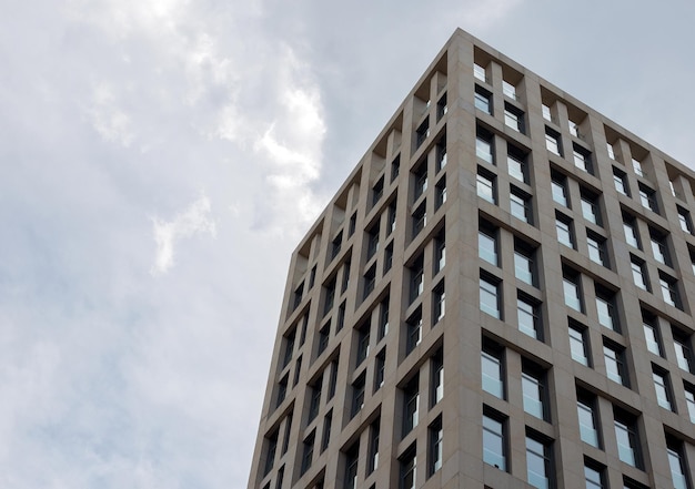 Bottom view on skyscraper on a background of blue sky