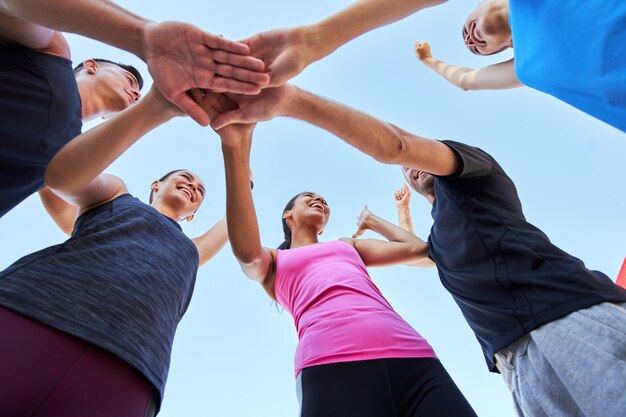 Bottom view of sport team with stacked in huddle hands