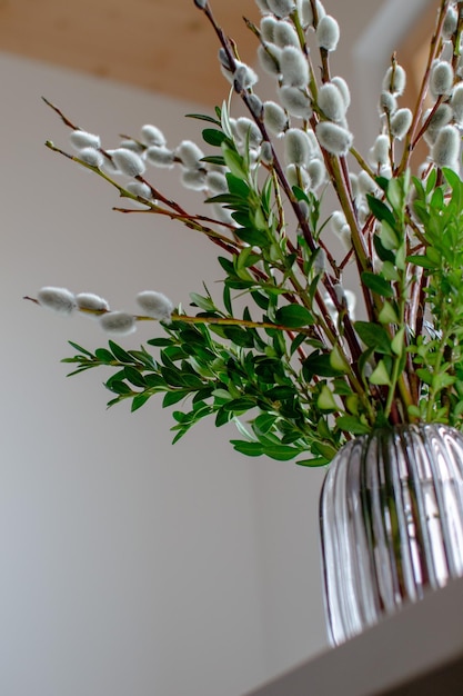 Bottom view of a vase filled with willow and boxwood