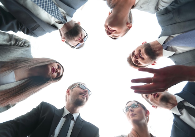 Bottom viewa group of employees stands forming a circl