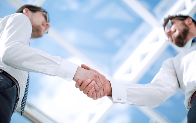 Bottom viewbackground image of a handshake of business people