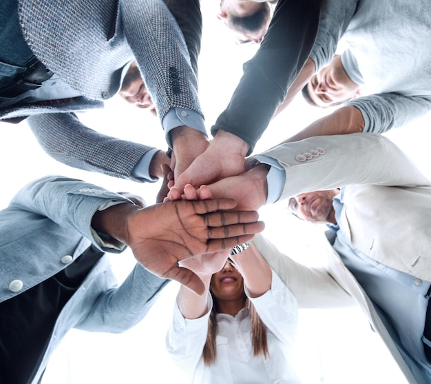 Bottom viewbusiness team folded their hands together