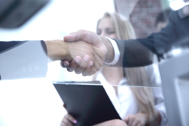 Bottom viewcloseup handshake financial partners business background