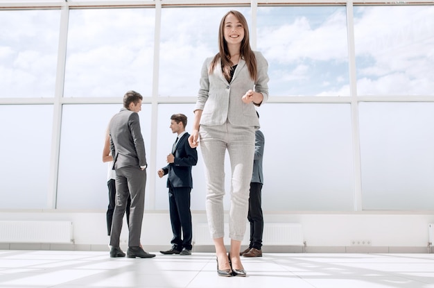 Bottom viewyoung businesswoman standing in a spacious lobby photo with copy space