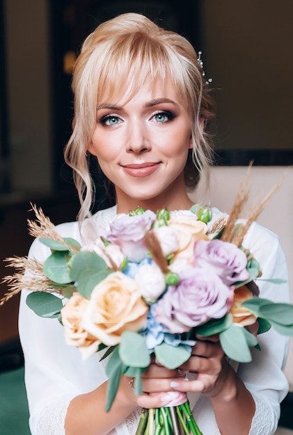 Boudoir of the bride. charming bride in the morning in a negligee prepares for the celebration