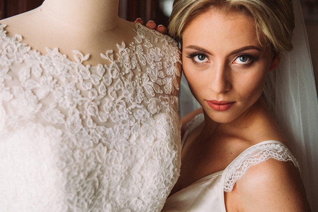 Boudoir of the bride. charming bride in the morning in a negligee prepares for the celebration