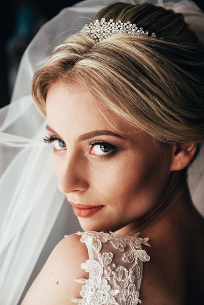 Boudoir of the bride. charming bride in the morning in a negligee prepares for the celebration