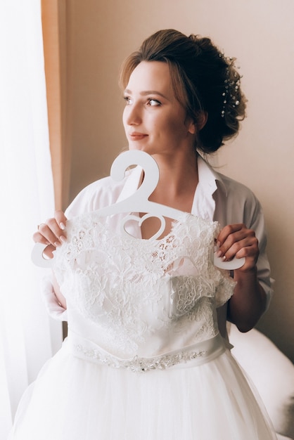 Boudoir of the bride. charming bride in the morning in a negligee prepares for the celebration