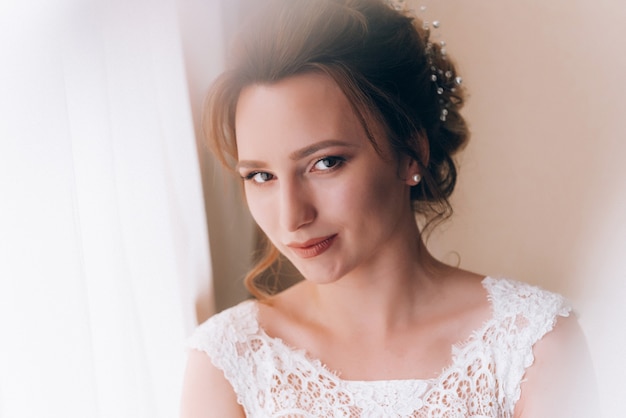 Boudoir of the bride. charming bride in the morning in a negligee prepares for the celebration