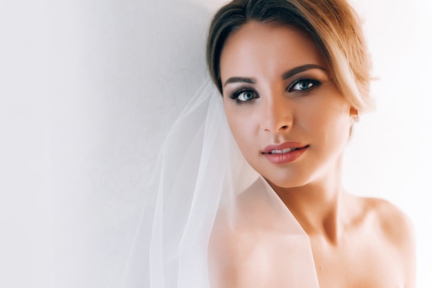 Boudoir of the bride. charming bride in the morning in a negligee prepares for the celebration