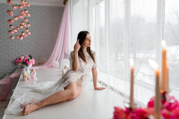 Boudoir morning of the bride. Bride stay near the window