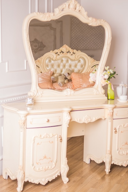 Boudoir table. details of the interior of the bedroom for girls and make-up, hairstyles with a mirror