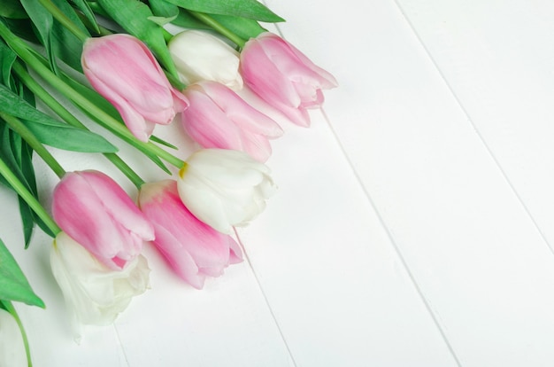 Bouqet of spring tilip flowers on white wooden table