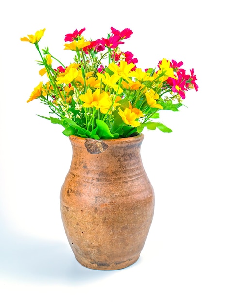 A bouquet of artificial flowers in a clay jug