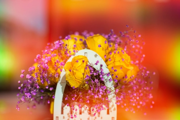 Bouquet of artificial flowers in orangeyellow gradient