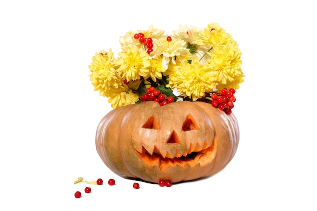 Bouquet of autumn yellow flowers in a pumpkin. Halloween