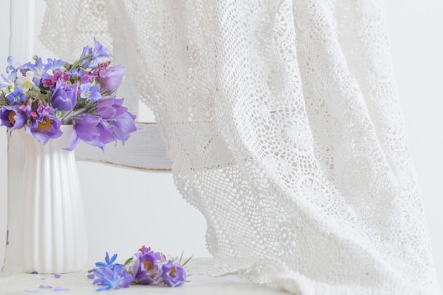 Bouquet of beautiful spring violet flowers on white