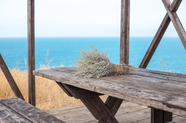 A bouquet of bitter fragrant wormwood in a wooden campsite on the seashore vacation and travel