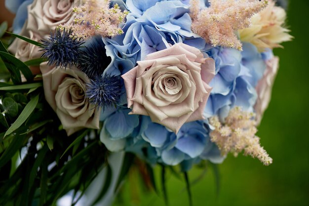 Bouquet of the bride with a powdery rose and blue hydrangeaWedding floristry