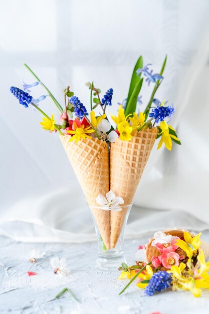 bouquet of bright spring flowers in a waffle cup background space for text