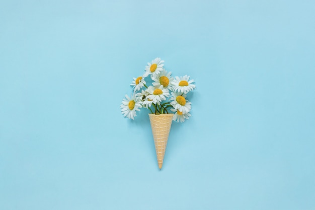 Bouquet chamomile daisies flowers in waffle ice cream