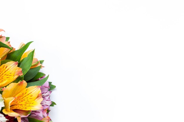 Bouquet of colorful flowers alstroemeria on white background flat lay horizontal mockup