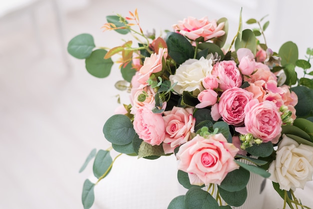 Bouquet composition with beautiful roses in a gift box.