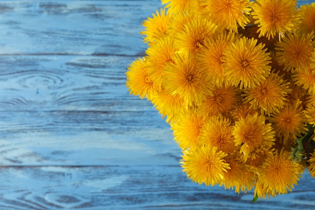 Bouquet of dandelions on wooden table