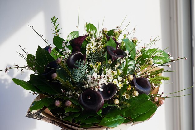 A bouquet of dark noble cal with frosted flower Floral