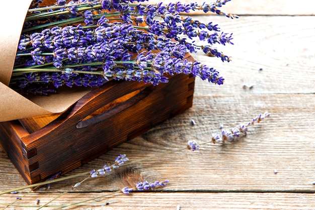 Bouquet of dried lavender in kraft paper in a wooden box