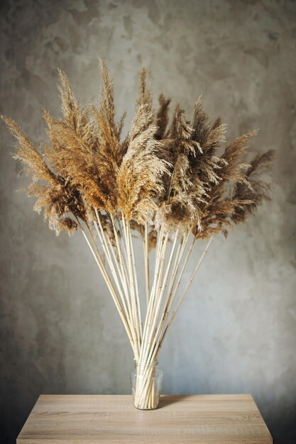 Photo bouquet of dried wild flowers on the background of a concrete wall