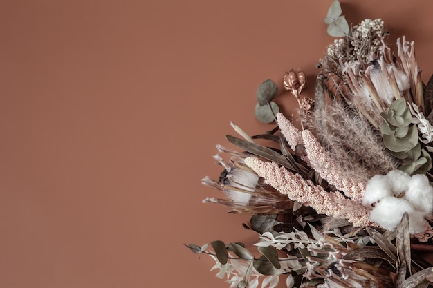 Bouquet of dried wildflowers, cotton and leaves composition